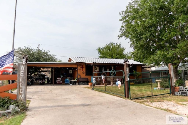 view of front of home with a front yard and a carport