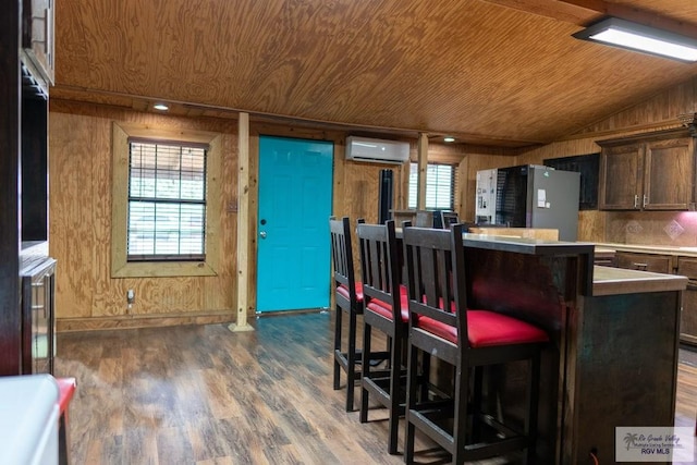 kitchen with dark hardwood / wood-style flooring, plenty of natural light, wood ceiling, and lofted ceiling