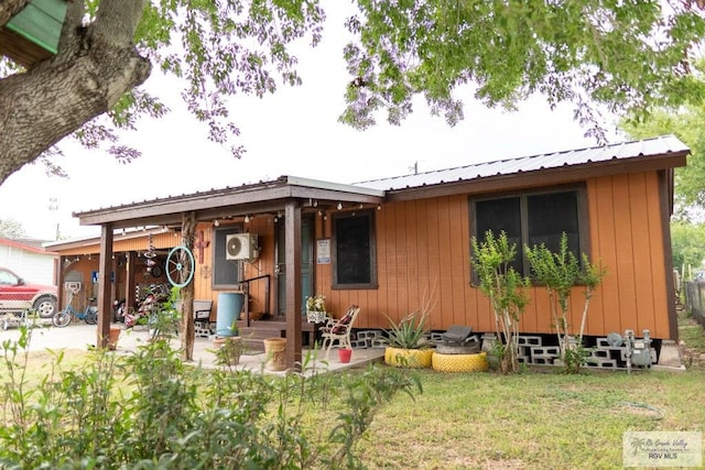 rear view of house featuring a yard