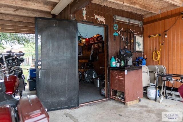 interior space with wood walls and concrete floors