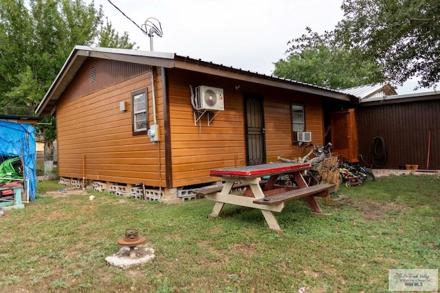 back of property featuring a lawn, ac unit, and cooling unit