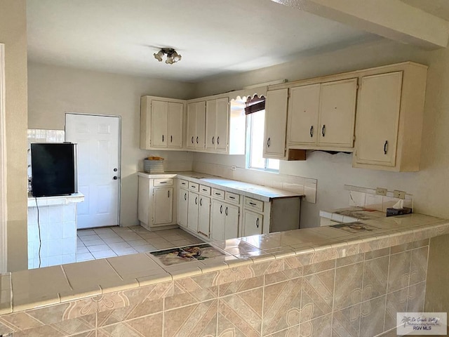 kitchen featuring tile counters and light tile patterned floors