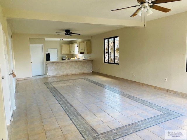 unfurnished living room with ceiling fan and light tile patterned flooring