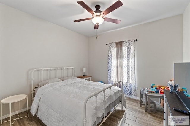 bedroom featuring ceiling fan and wood-type flooring