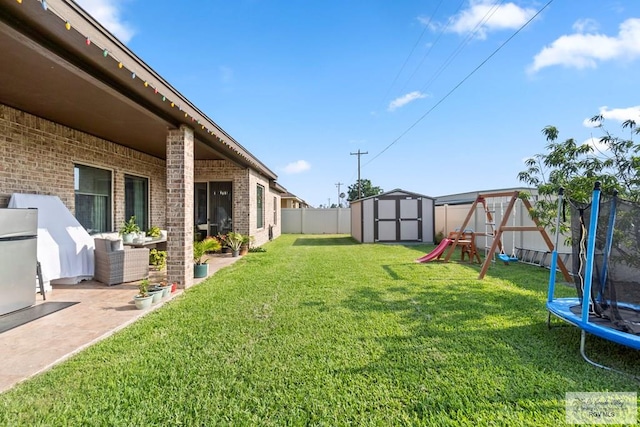 view of yard featuring a playground, a trampoline, a shed, and a patio area