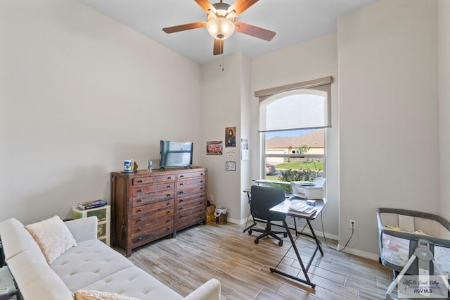 office area with ceiling fan and light hardwood / wood-style floors