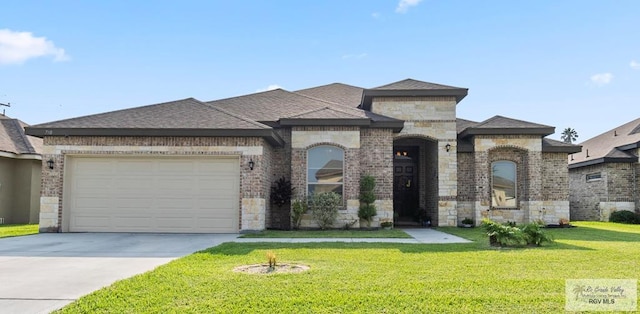 view of front of house featuring a garage and a front lawn