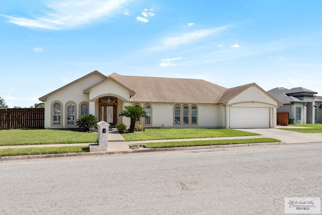 ranch-style home featuring a front lawn and a garage