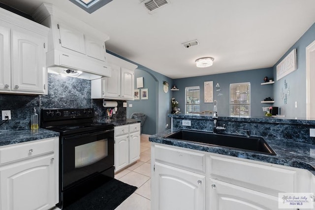 kitchen featuring black electric range oven, white cabinets, ventilation hood, sink, and light tile patterned floors