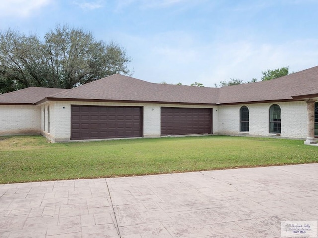 ranch-style house featuring a front yard and a garage