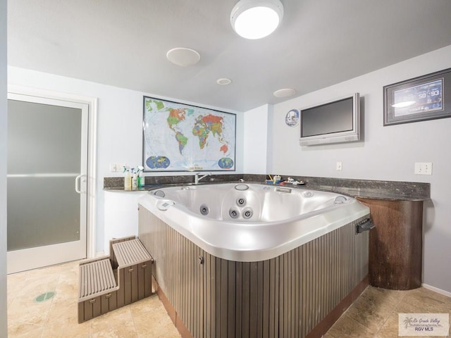 bathroom featuring tile patterned flooring and a tub