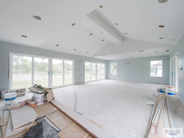 living room featuring lofted ceiling with beams and french doors