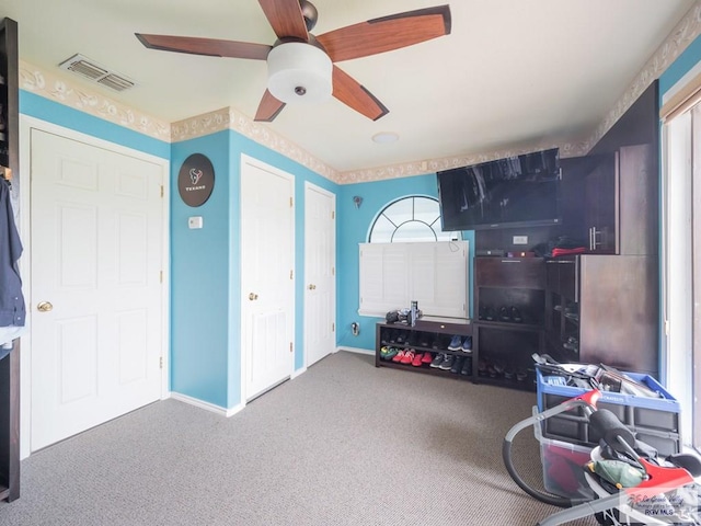 misc room with carpet flooring and ceiling fan