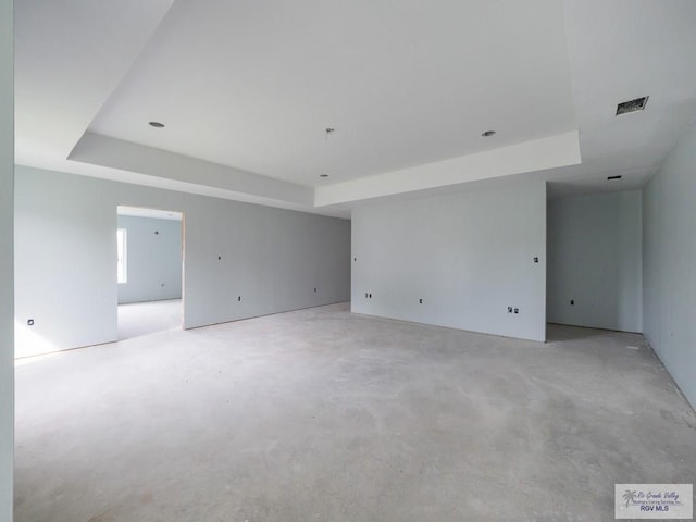 spare room with a tray ceiling