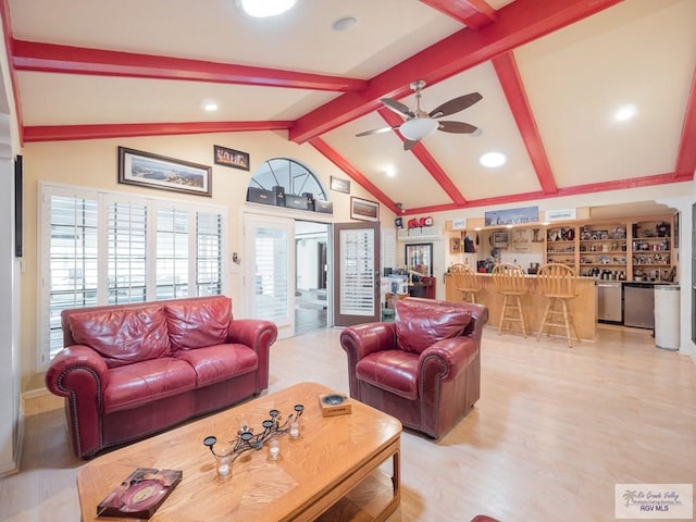 living room featuring ceiling fan, beamed ceiling, high vaulted ceiling, light hardwood / wood-style floors, and indoor bar