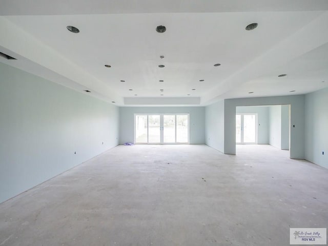 empty room featuring a raised ceiling