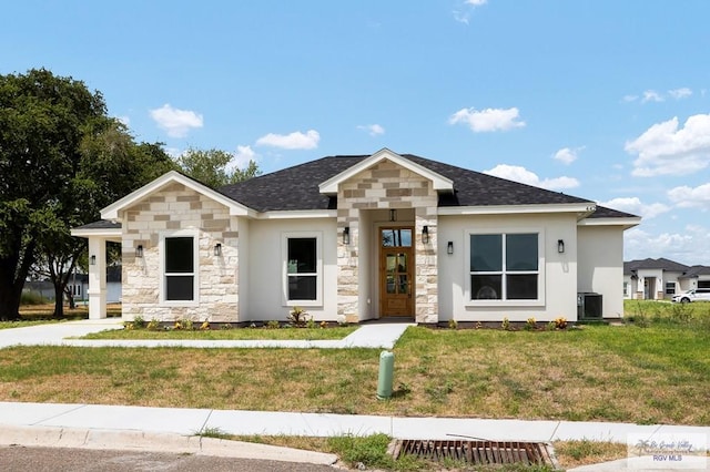 view of front of property featuring a front lawn and central air condition unit