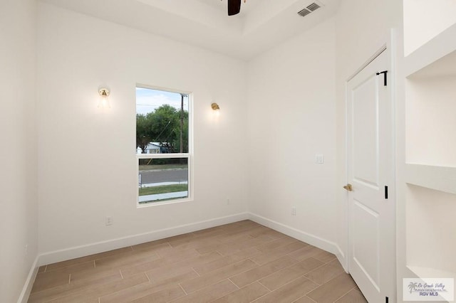 spare room featuring light wood-type flooring and ceiling fan