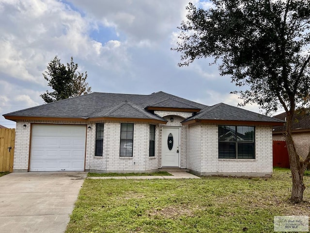 view of front of house with a garage and a front yard