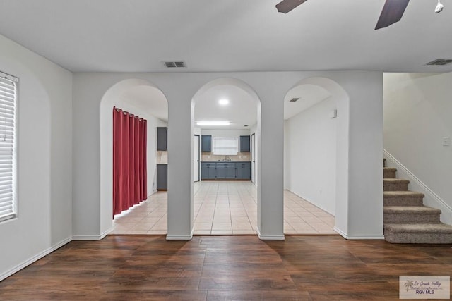 3017 Paradise Ave, Harlingen, TX 78552 - unfurnished living room with a ceiling fan, wood finished floors, stairs, and baseboards
