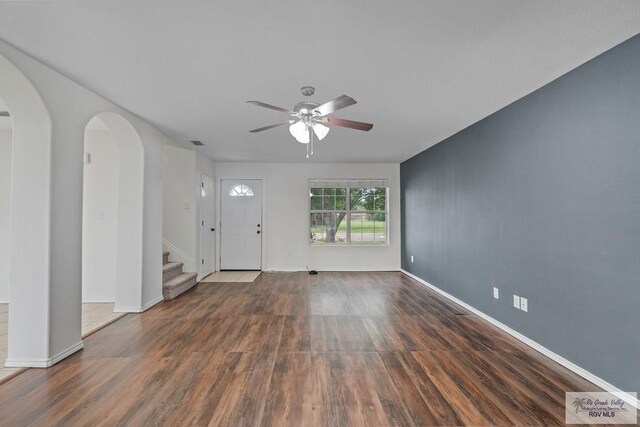 3017 Paradise Ave, Harlingen, TX 78552 - foyer entrance featuring ceiling fan, wood finished floors, arched walkways, and stairs