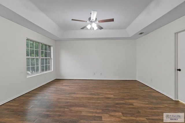3017 Paradise Ave, Harlingen, TX 78552 - empty room with a tray ceiling, a ceiling fan, wood finished floors, and baseboards