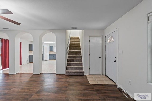 3017 Paradise Ave, Harlingen, TX 78552 - foyer featuring ceiling fan, wood finished floors, stairs, arched walkways, and baseboards