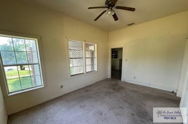 309 E Polk Ave, Harlingen, TX 78550 - empty room with healthy amount of natural light, carpet, and a ceiling fan