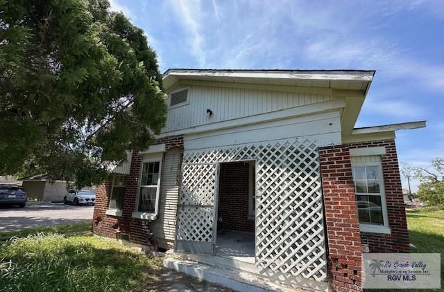 309 E Polk Ave, Harlingen, TX 78550 - view of property exterior with brick siding
