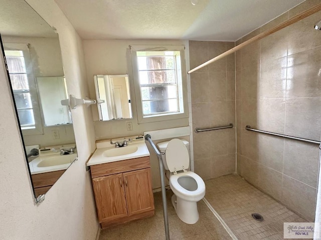 309 E Polk Ave, Harlingen, TX 78550 - bathroom with vanity, toilet, and tiled shower