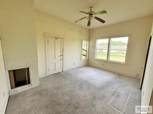 309 E Polk Ave, Harlingen, TX 78550 - unfurnished living room featuring a ceiling fan and carpet flooring