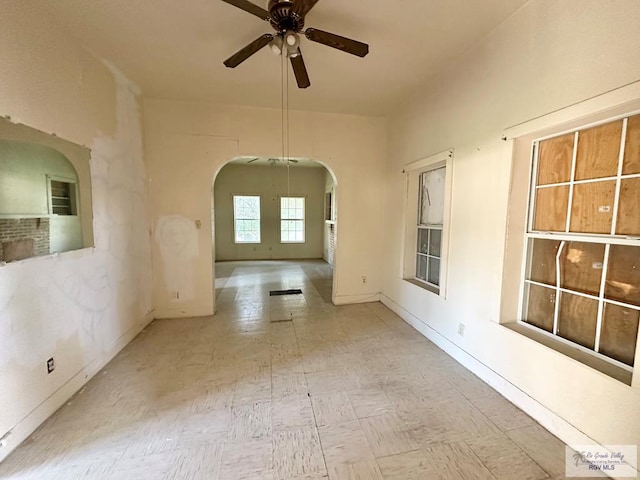309 E Polk Ave, Harlingen, TX 78550 - unfurnished room featuring arched walkways, a ceiling fan, and baseboards