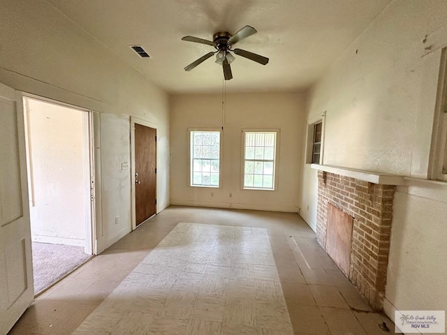 309 E Polk Ave, Harlingen, TX 78550 - unfurnished living room with a ceiling fan and a brick fireplace