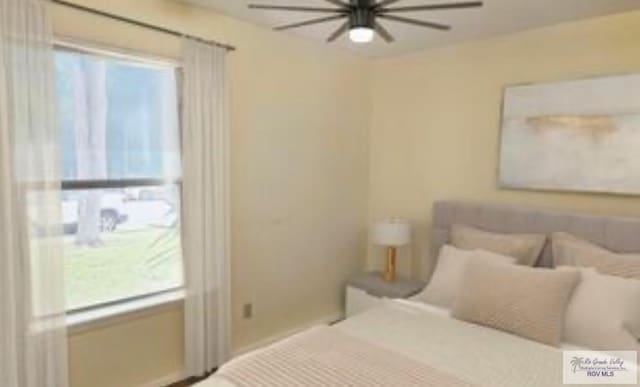 2201 Emerald Lake Dr, Harlingen, TX 78550 - bedroom featuring multiple windows and a ceiling fan
