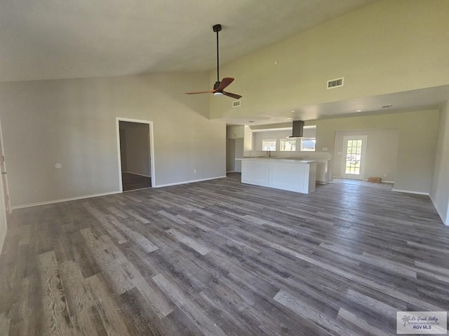 1115 Falcon Dr, Harlingen, TX 78550 - unfurnished living room featuring a ceiling fan, dark wood-type flooring, and high vaulted ceiling