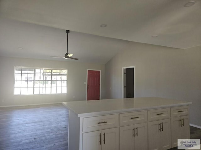 1115 Falcon Dr, Harlingen, TX 78550 - kitchen featuring white cabinets, a ceiling fan, dark wood-style flooring, lofted ceiling, and light countertops