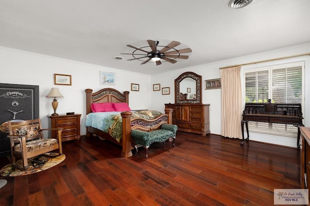 bedroom featuring ceiling fan, ornamental molding, and dark wood-type flooring