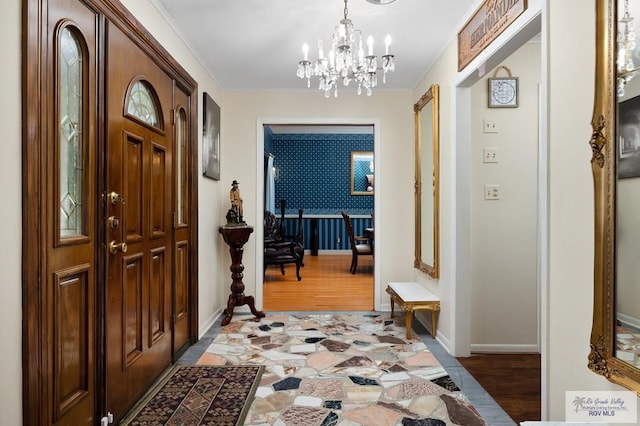 foyer with dark hardwood / wood-style flooring and a notable chandelier