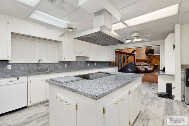 kitchen featuring dishwasher, wooden walls, decorative backsplash, black electric cooktop, and island range hood