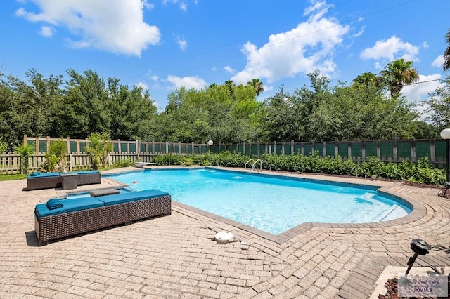 view of swimming pool with a patio area