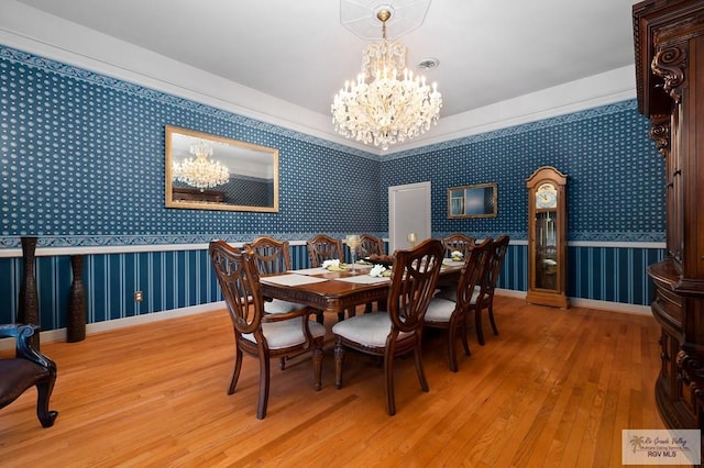 dining area featuring a chandelier and wood-type flooring