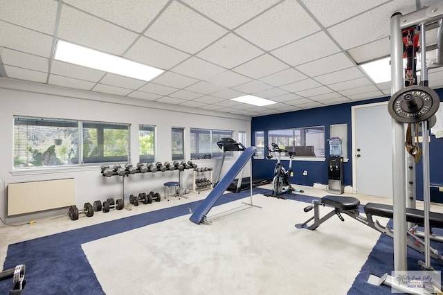 exercise area with a paneled ceiling and a wealth of natural light