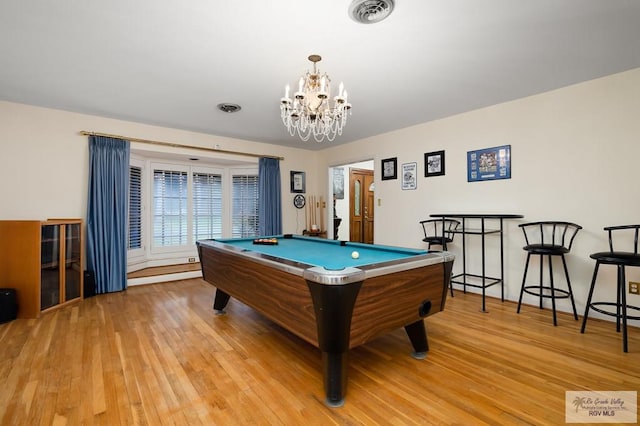 rec room featuring light hardwood / wood-style flooring, a notable chandelier, and pool table