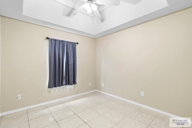 spare room featuring ceiling fan and light tile patterned flooring