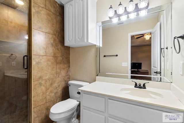 bathroom featuring vanity, toilet, and an enclosed shower