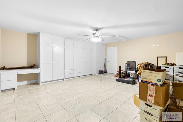 basement with ceiling fan and light tile patterned floors