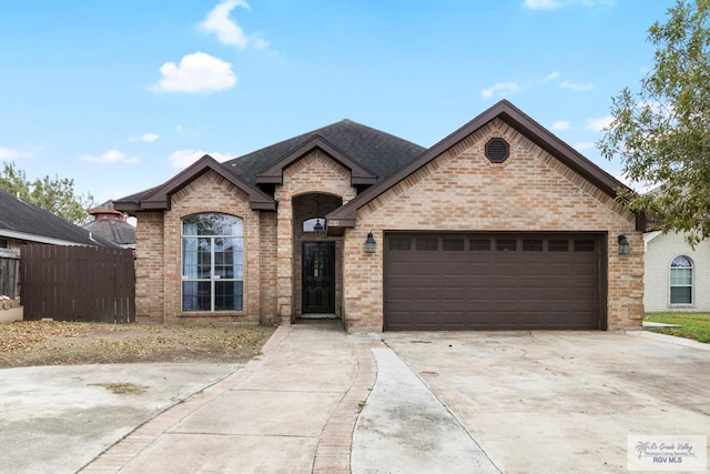 french provincial home featuring a garage