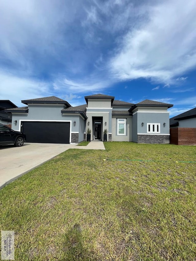 prairie-style home with a garage and a front yard