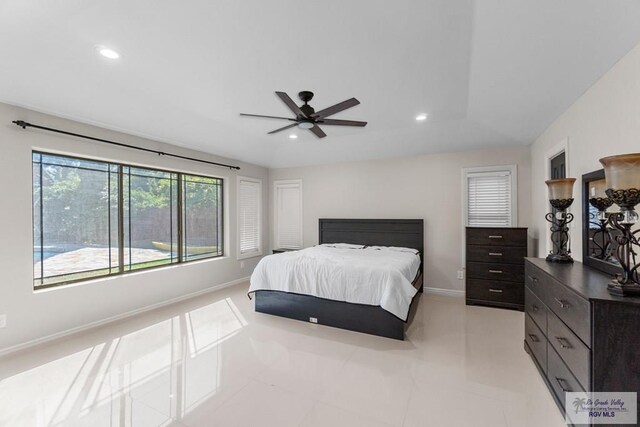 bedroom with ceiling fan, light tile patterned floors, and lofted ceiling