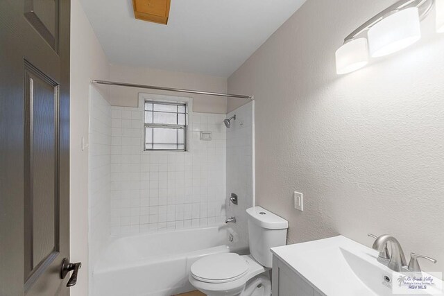 full bathroom featuring vanity, toilet, and tiled shower / bath combo